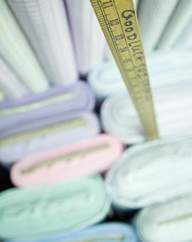 rolls of shirt fabric and measure ruler