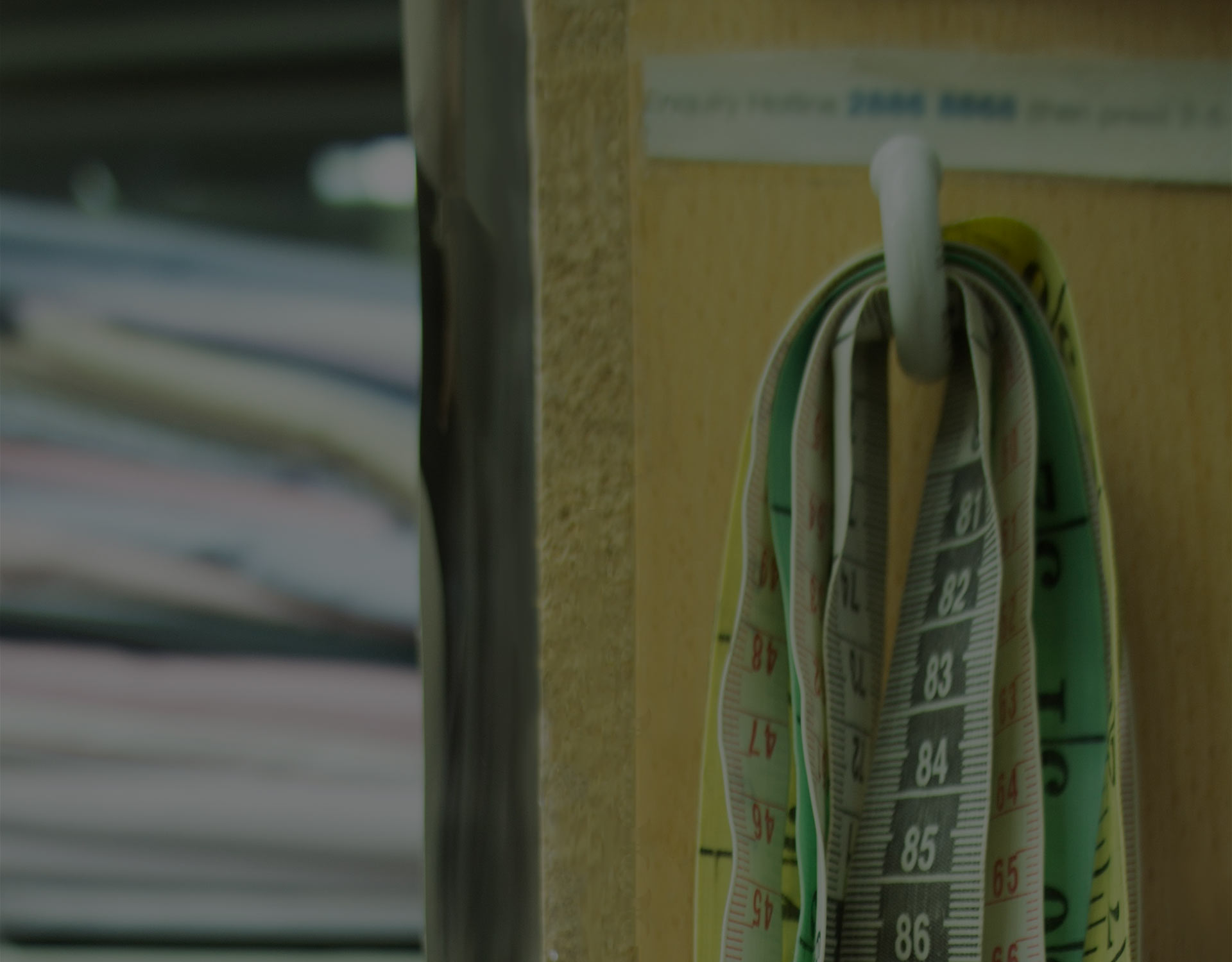 Measuring tape on a wall hook